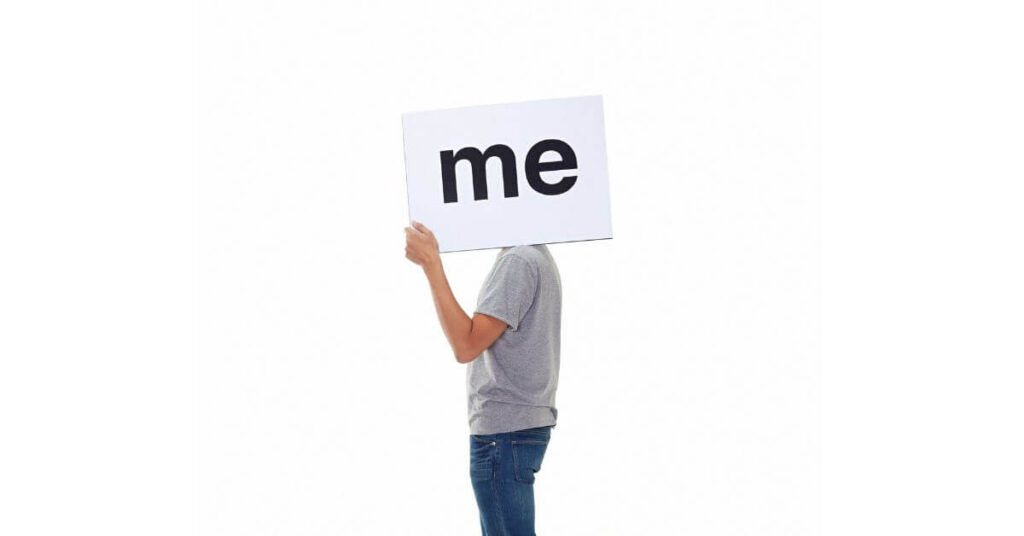 Economy of Me: Working as an independent project manager - individual holding up a sign that says "me"