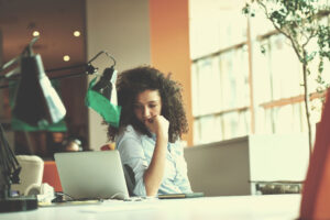 Woman contemplating something on her computer. 